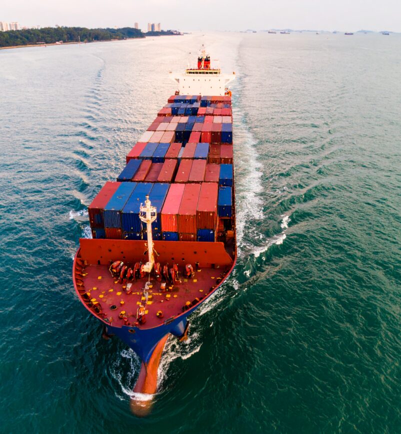 Firefly_Ultra-realistic aerial photograph of a large cargo ship passing through the Singapore 245503 (1)